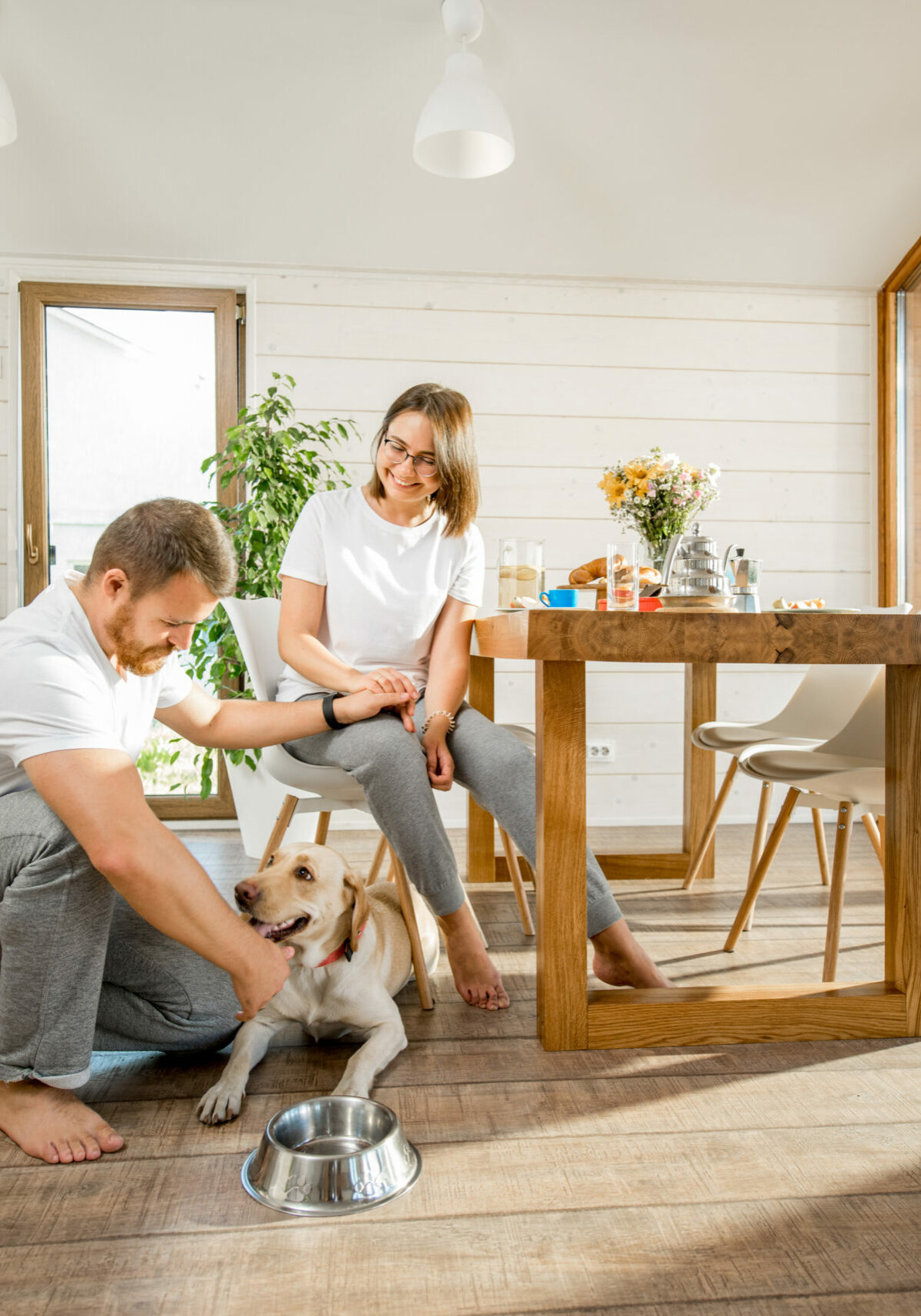 Young couple with dog at home | Floor to Ceiling Winter Garden